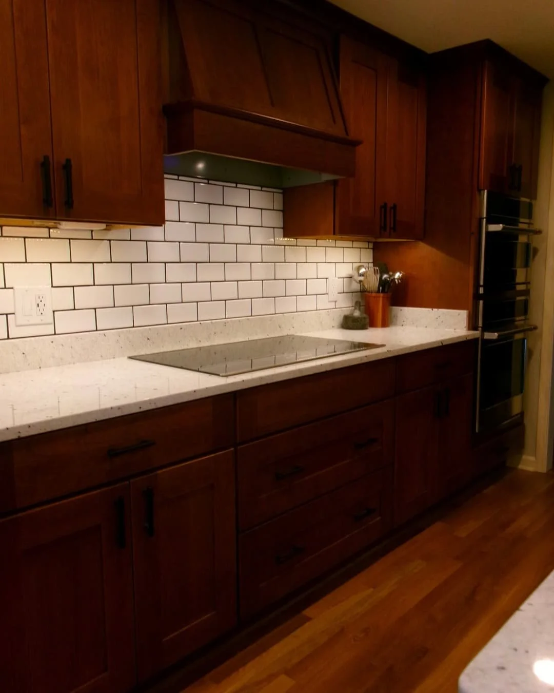 Open kitchen remodel in a Fayetteville, NY home with granite countertops, island seating, and wood cabinetry.