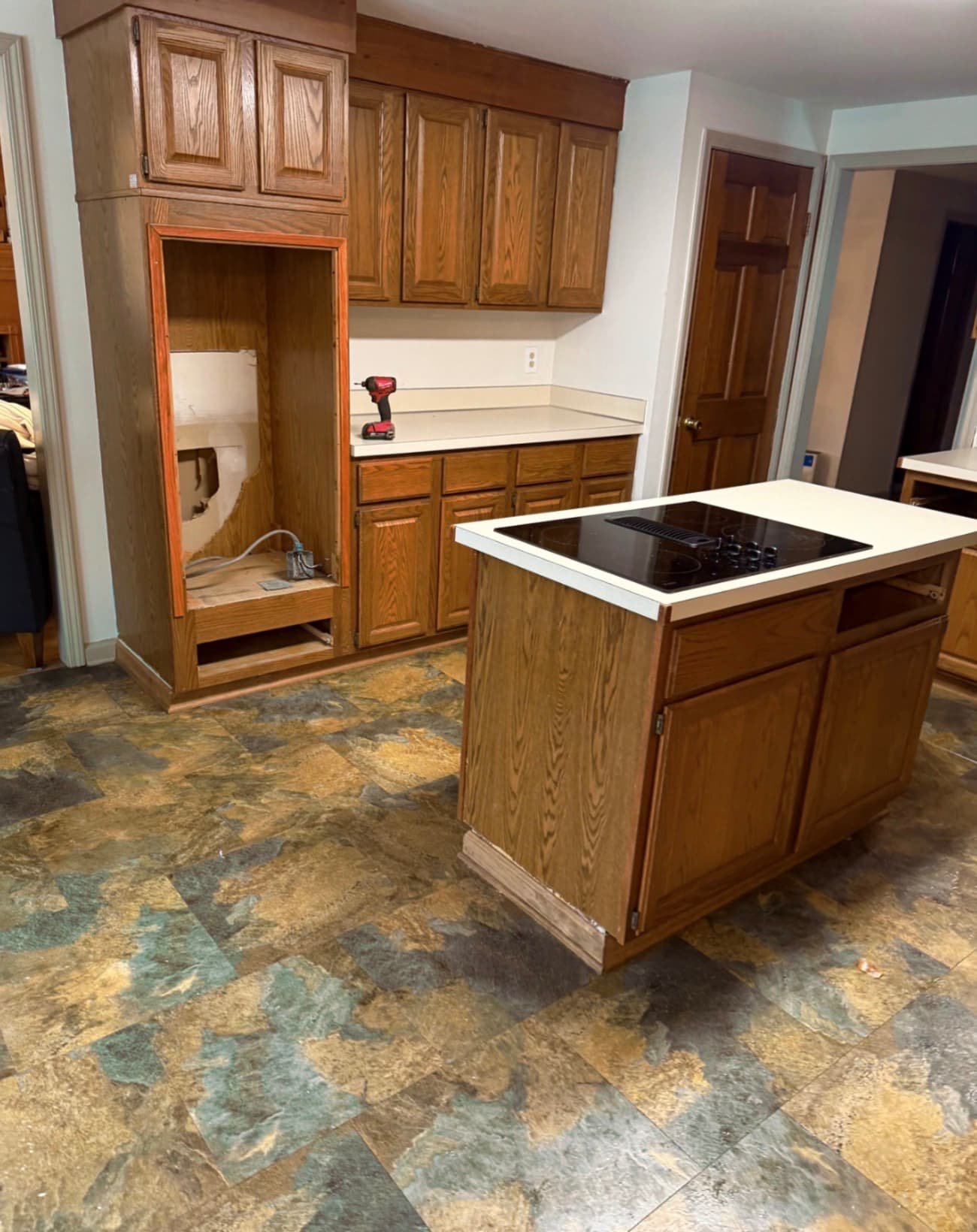 Kitchen remodel in Central New York with a center island, granite countertops, and warm wood cabinetry.