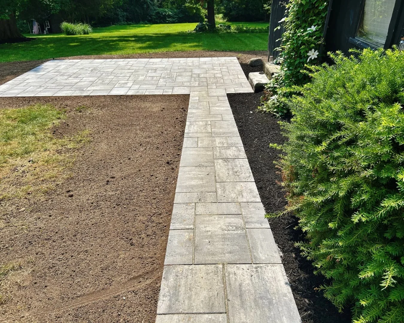 Paver border and garden bed completed by Pines and Pavers in Cazenovia, New York.
