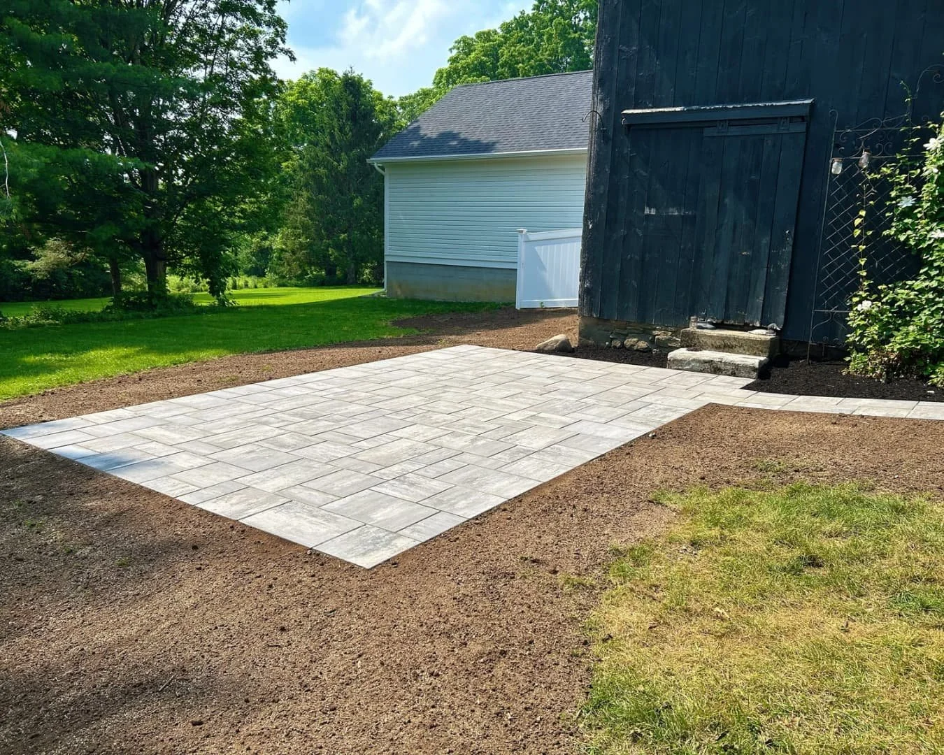 Paver walkway by the foundation bed completed by Pines and Pavers in Cazenovia, New York.