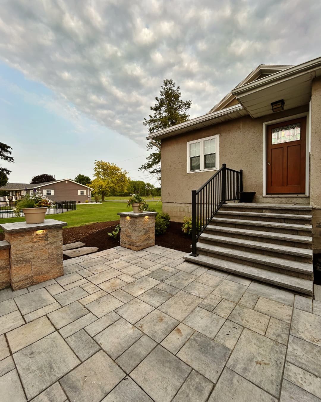Front entry paver patio and steps completed by Pines and Pavers in Fayetteville, New York.