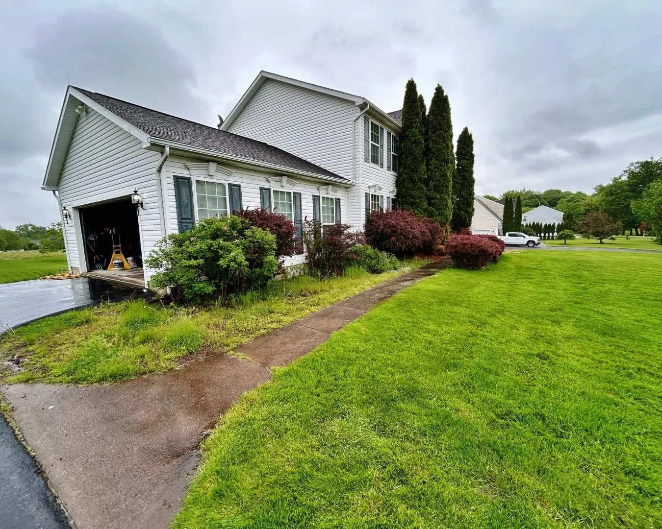Front walkway and lawn before the project by Pines and Pavers in Baldwinsville, New York.