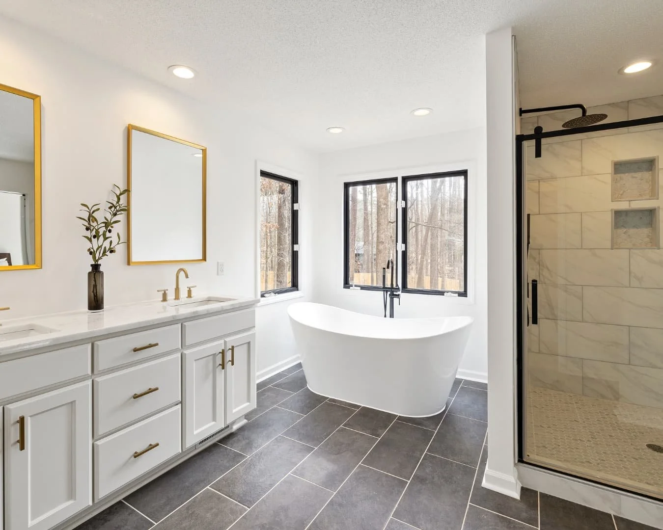 Bathroom inspiration featuring a double vanity, glass shower, and warm neutral finishes.