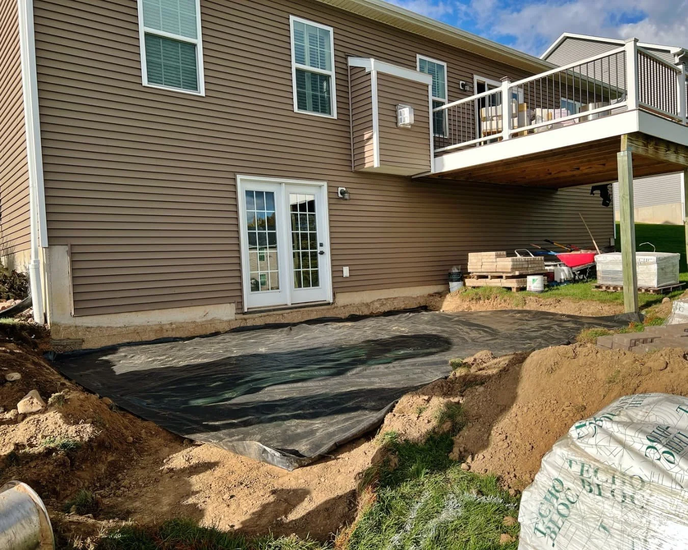Rear yard grade and patio overview completed by Pines and Pavers in Lysander, New York.
