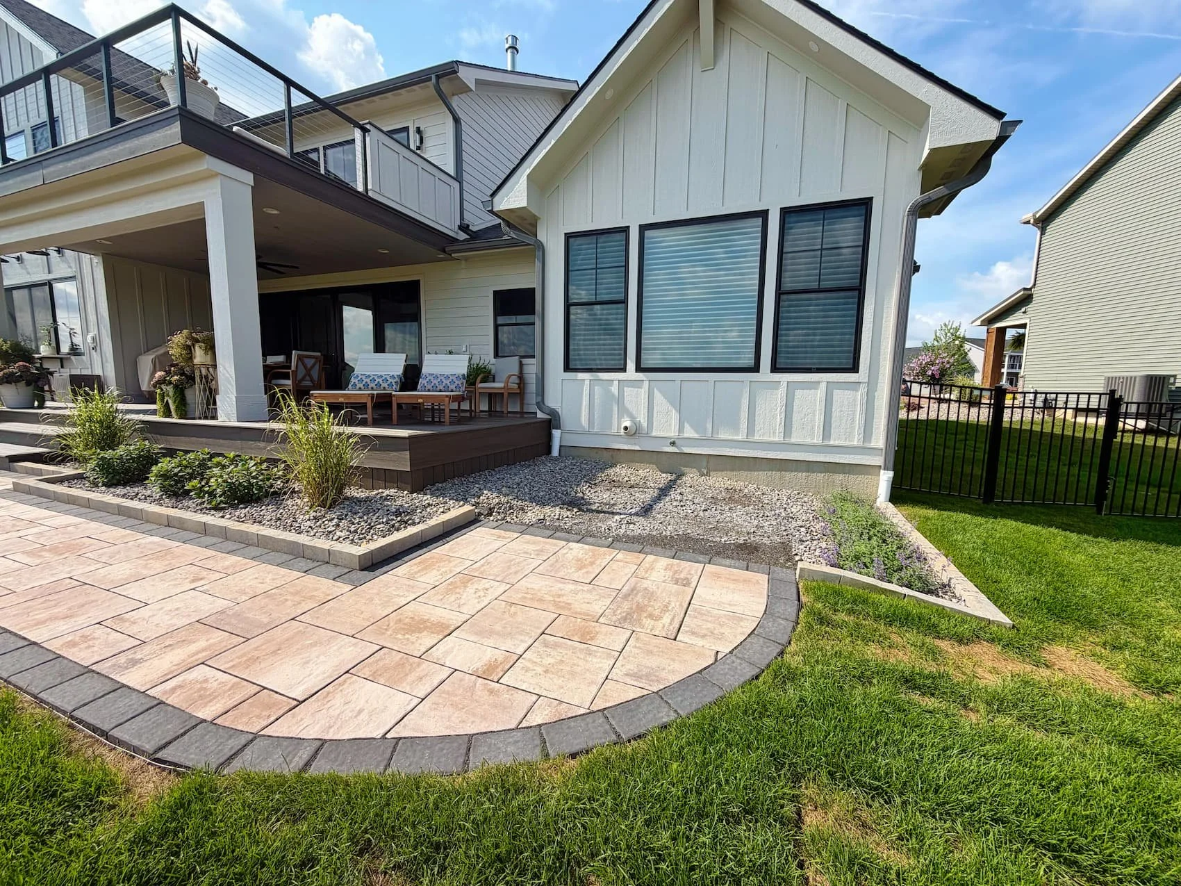 Paver walkway bordered by decorative stone and landscaping in Central New York