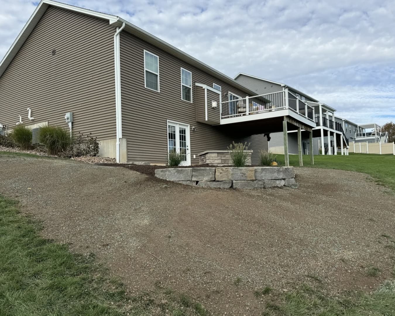 Paver patio with built-in fire pit at a Baldwinsville, NY outdoor living project.