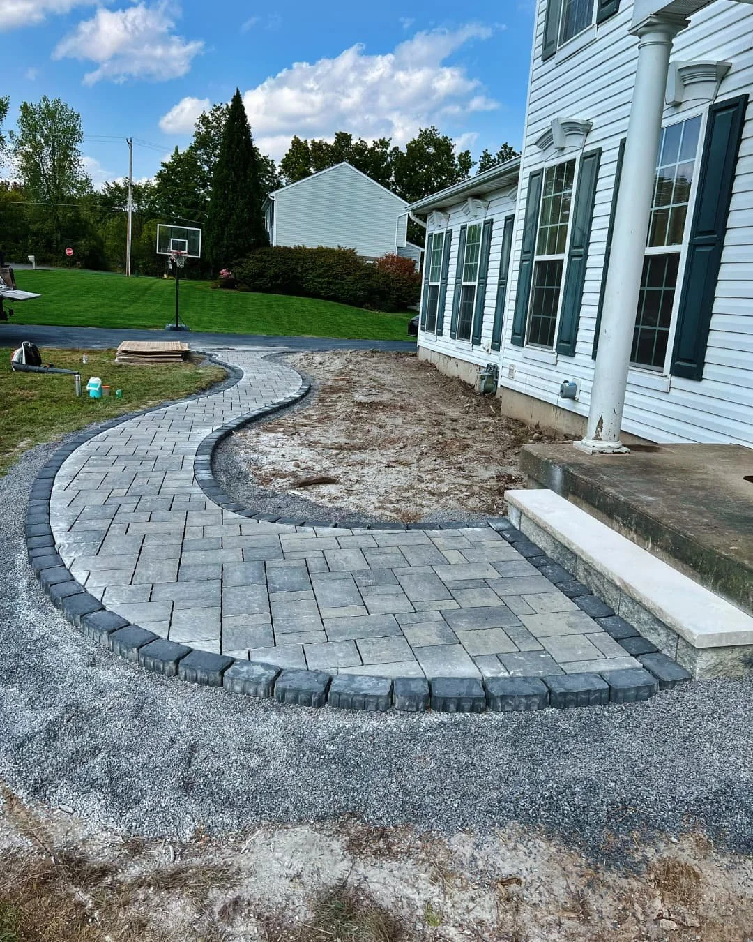 Curved paver patio and walkway completed by Pines and Pavers in Baldwinsville, New York.