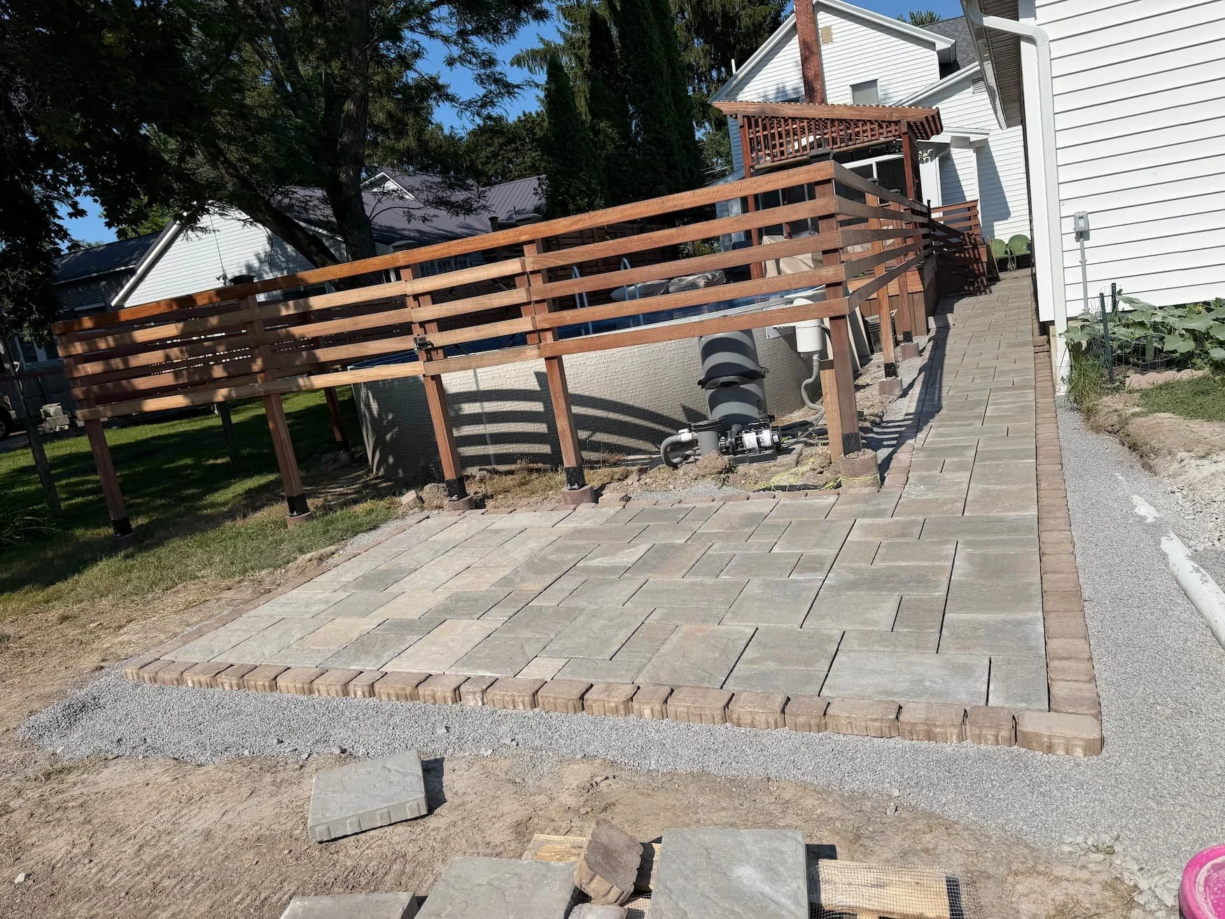 Existing area beside a raised deck being prepared for a new paver installation in Central New York.