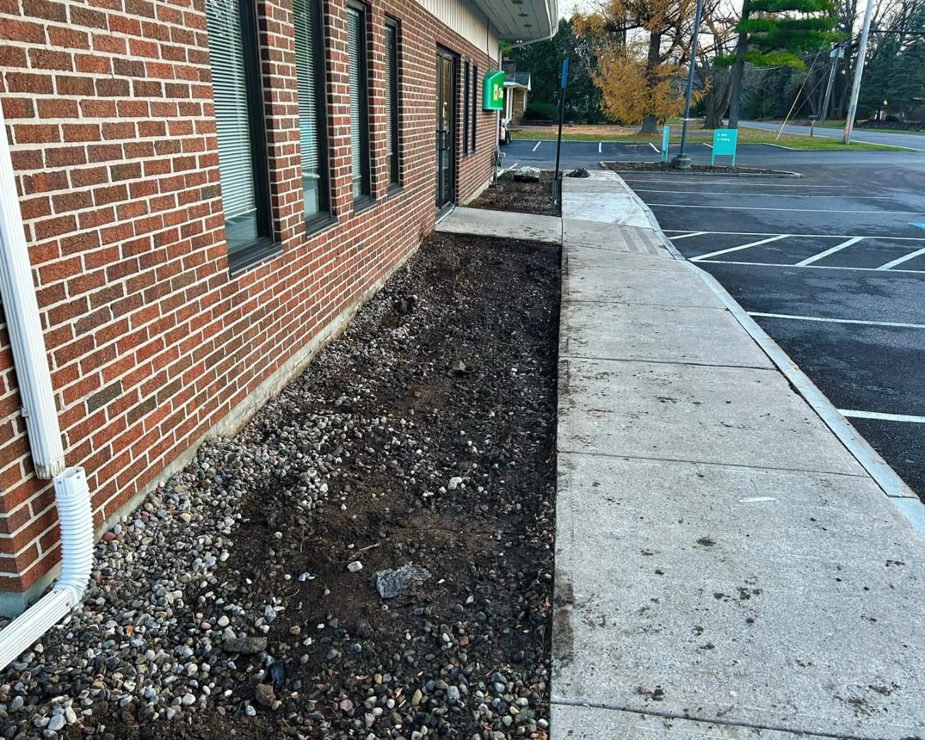Foundation bed preparation at Citizens Bank by Pines and Pavers in Cicero, New York.