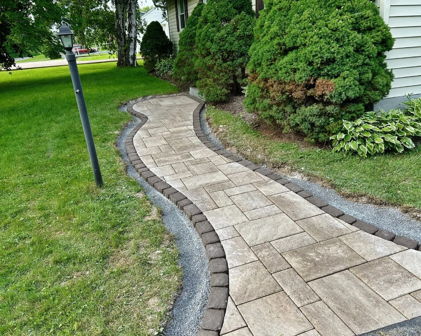 Curved paver walkway completed by Pines and Pavers in Central New York.