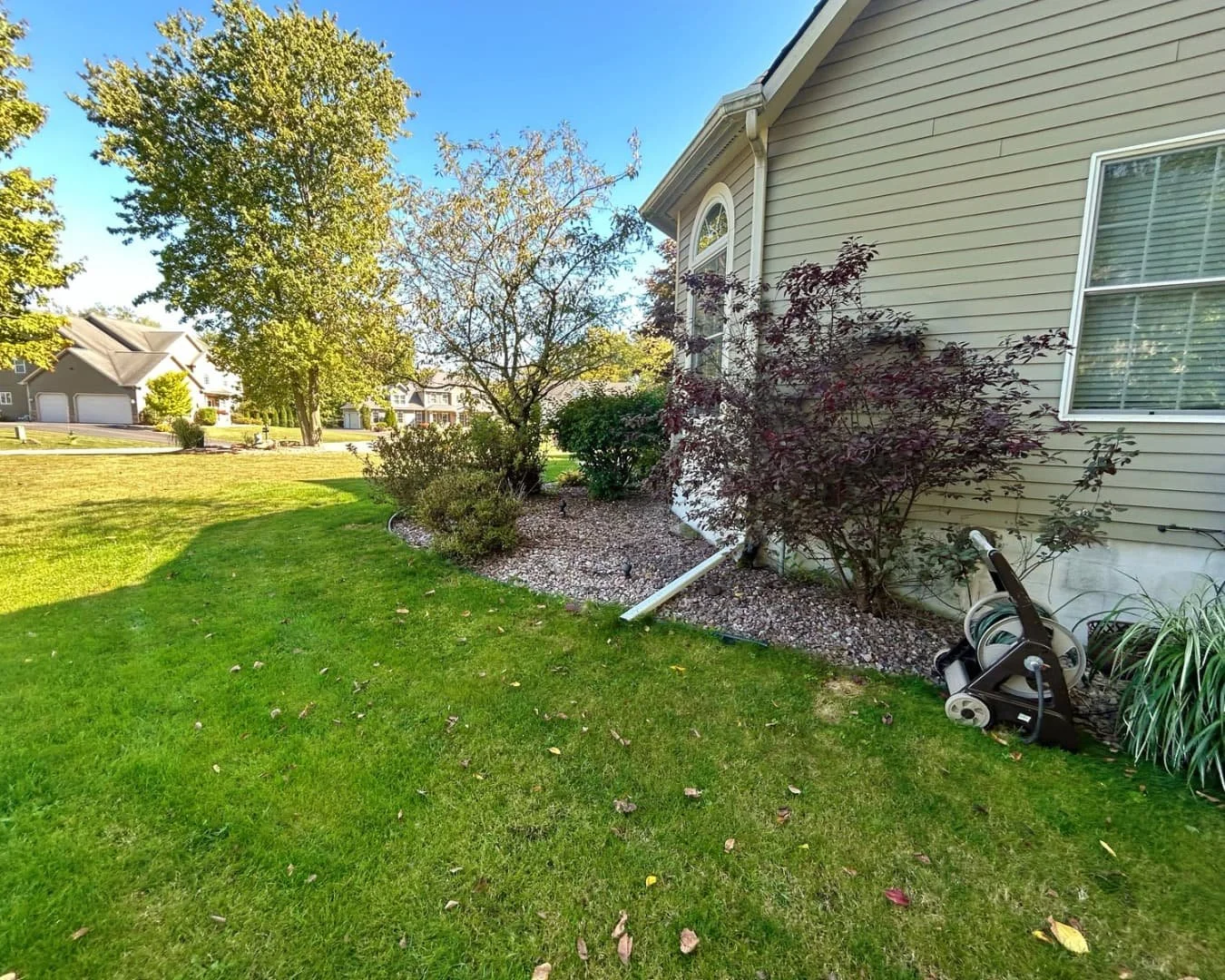 Foundation bed and shrub border by Pines and Pavers in Fayetteville, New York.