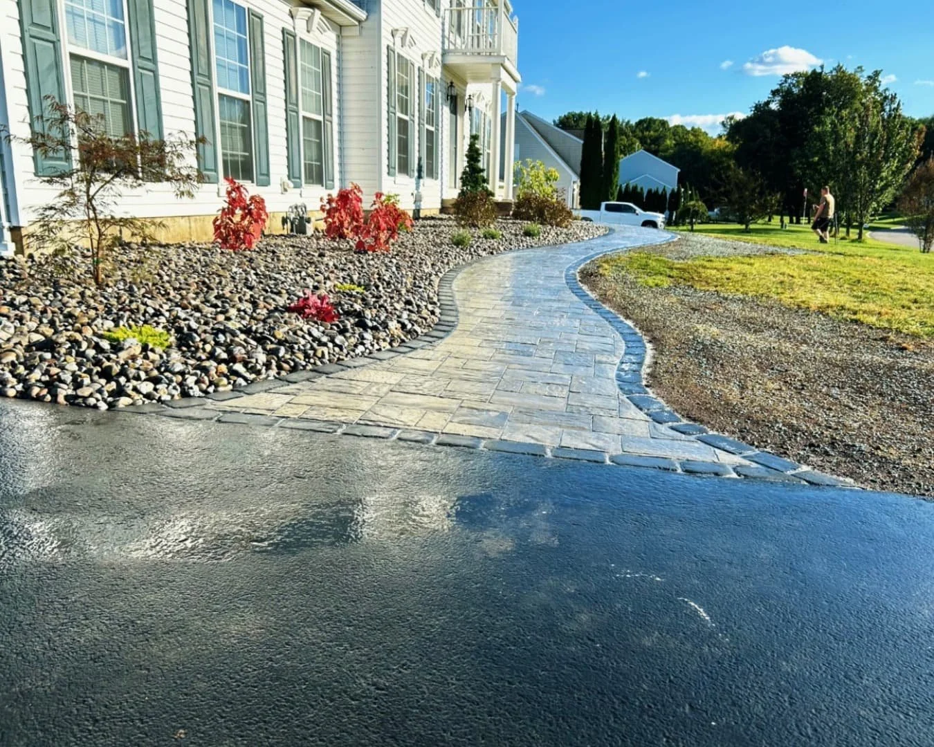 Decorative rock border and landscape bed detail at a Central New York hardscape and landscaping project.