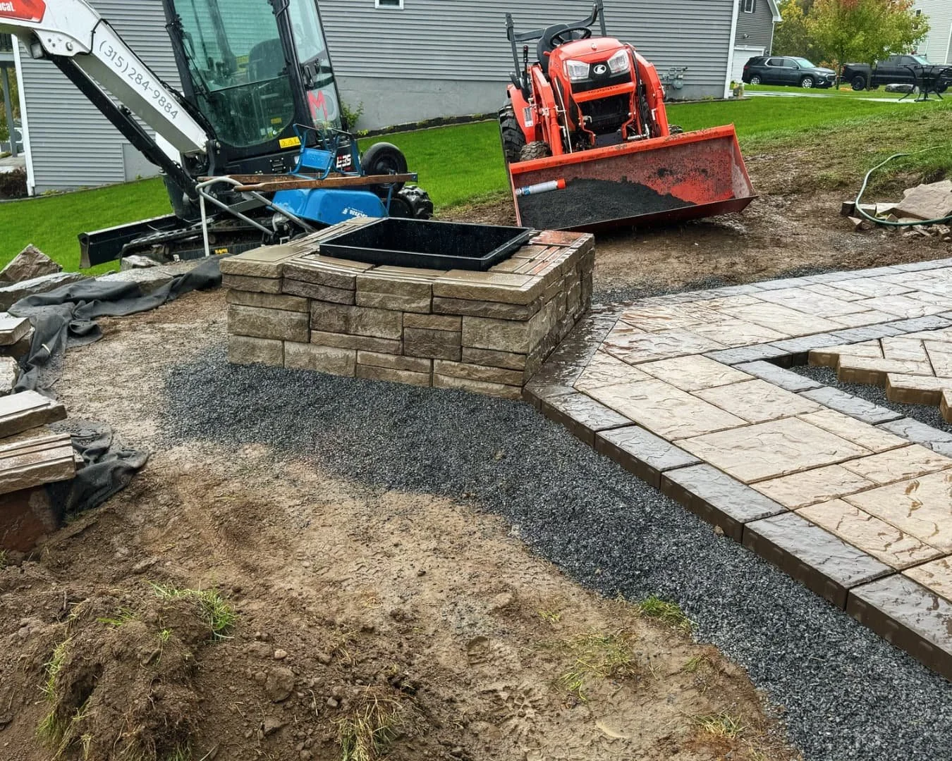 Completed under-deck paver patio by Pines and Pavers in Lysander, New York.