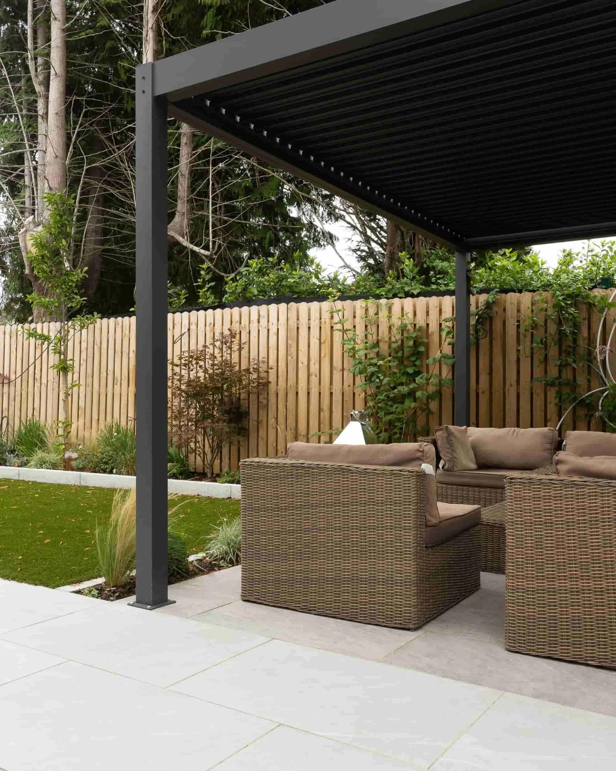 Modern patio installation with pergola and outdoor lounge seating