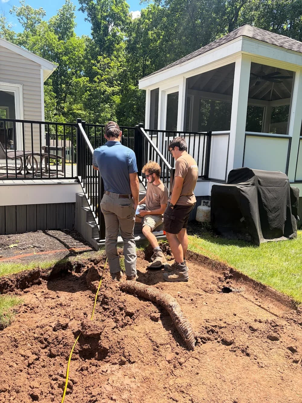 Crew at Pines and Pavers getting ready for a patio transformation. 
