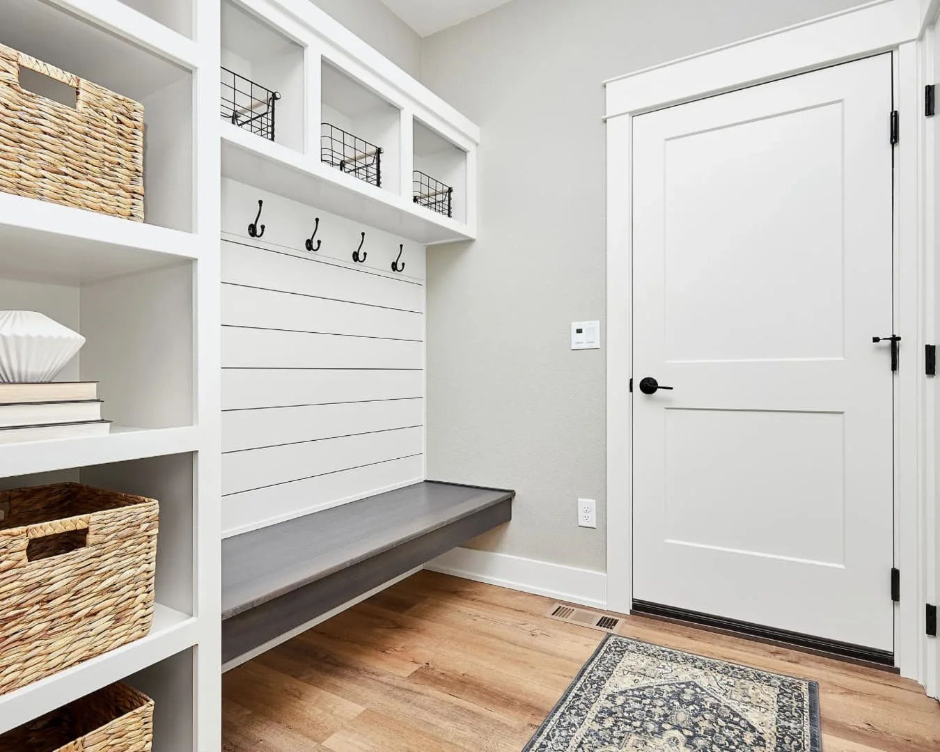Mudroom inspiration with wood locker-style storage, bench seating, and a warm functional entry design.