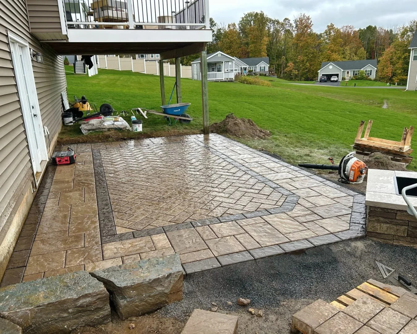 Square paver pad installation by Pines and Pavers in Lysander, New York.