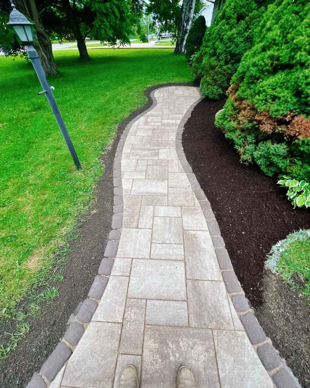 Front paver walkway leading to the home entry completed by Pines and Pavers in Central New York.
