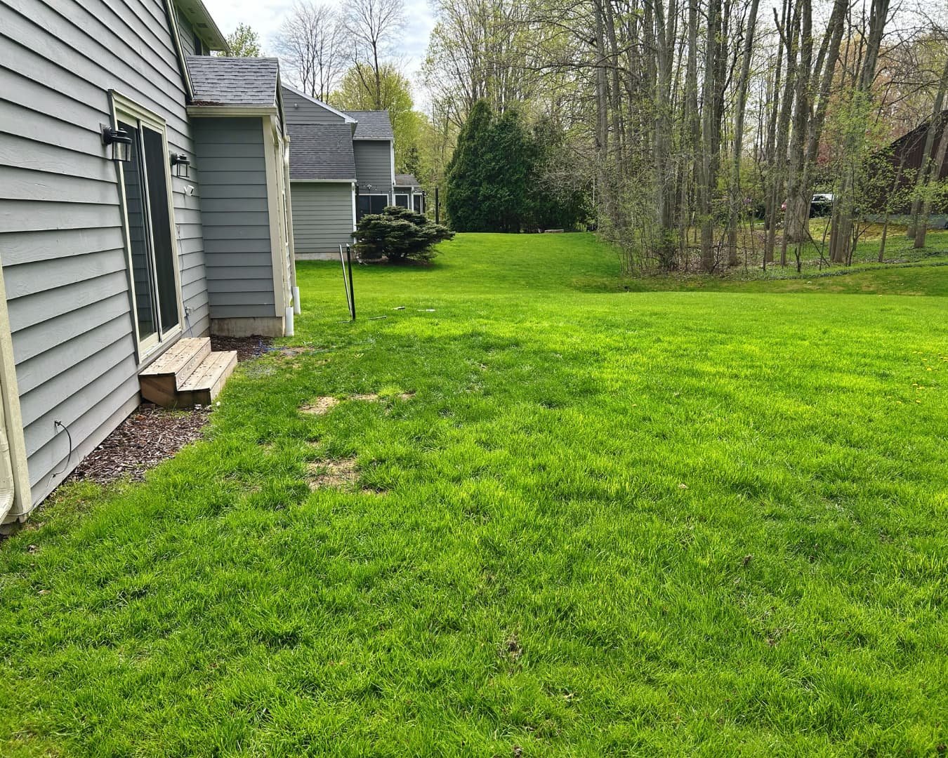 Backyard overview before the patio project by Pines and Pavers in Brewerton, New York.