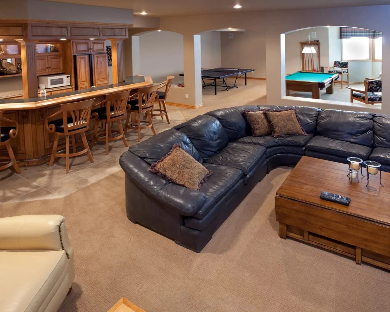 Basement inspiration with a finished family room, lounge seating, and a bar area for entertaining.