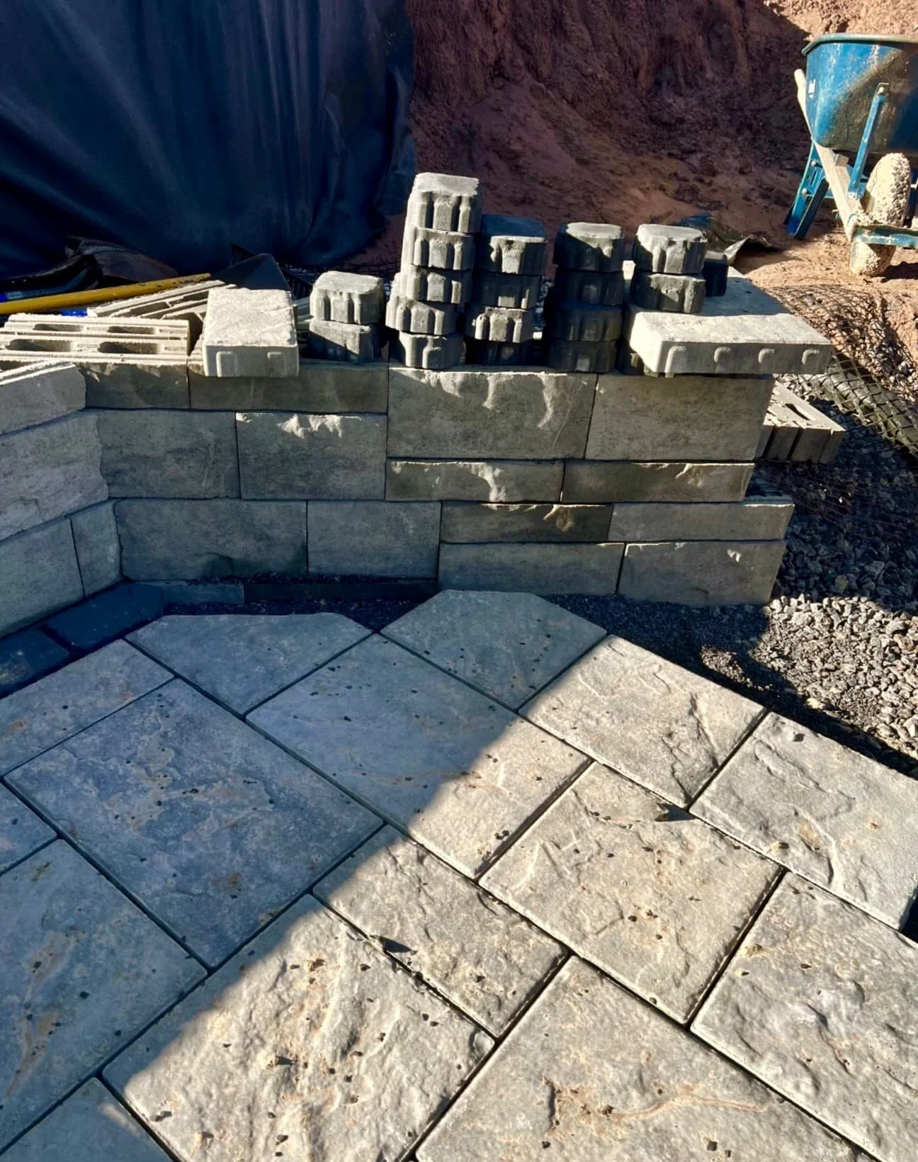 Stone steps and retaining wall at a Central New York home with a tiered hardscape design in progress.