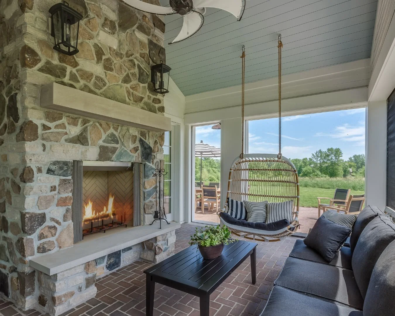 Outdoor fireplace inspiration with a covered patio, fireplace, and large seating area for entertaining.
