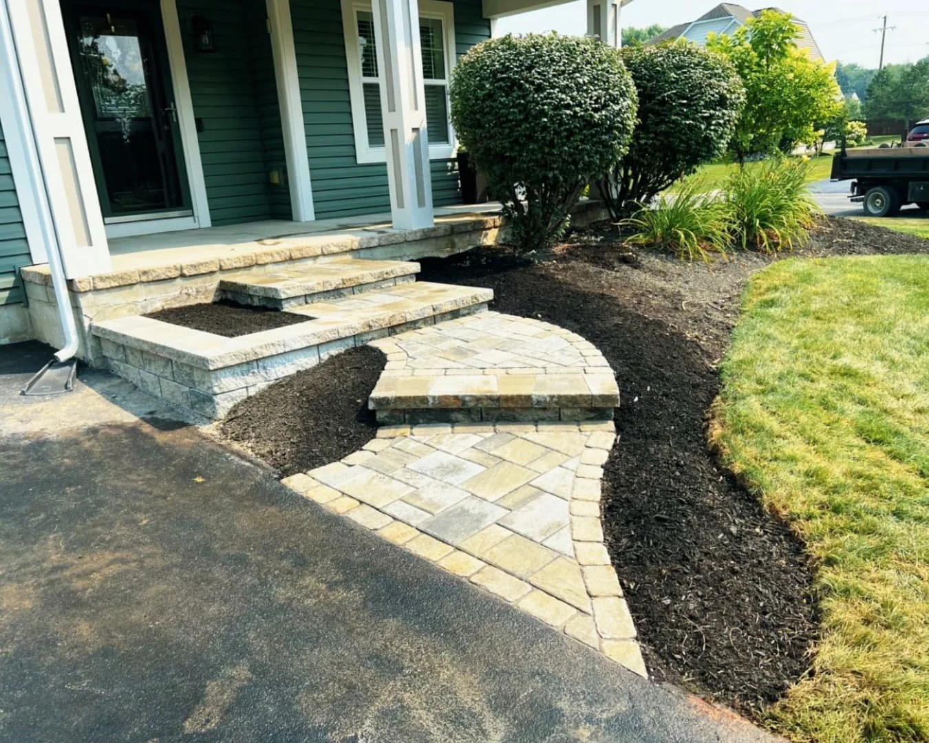 Front walkway and curved entry steps at an Upstate New York home with a newly built hardscape design.