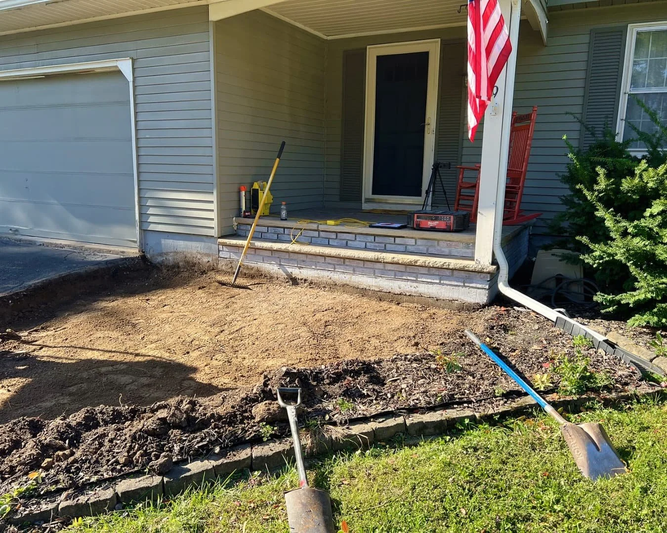 Front entry paver detail at a Central New York home with blended stone tones and a finished curved edge.
