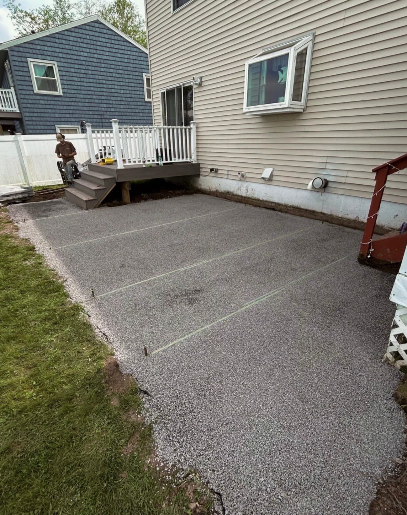 Side patio and lawn transition at a Central New York home with clean paver lines and finished grading.