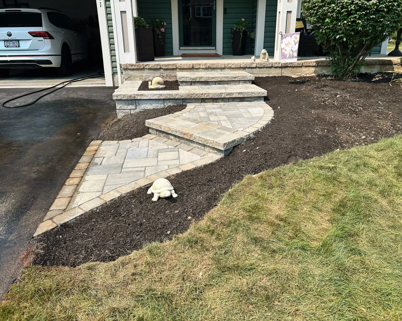 Front entry paver walkway and bed detail completed by Pines and Pavers in Manlius, New York.