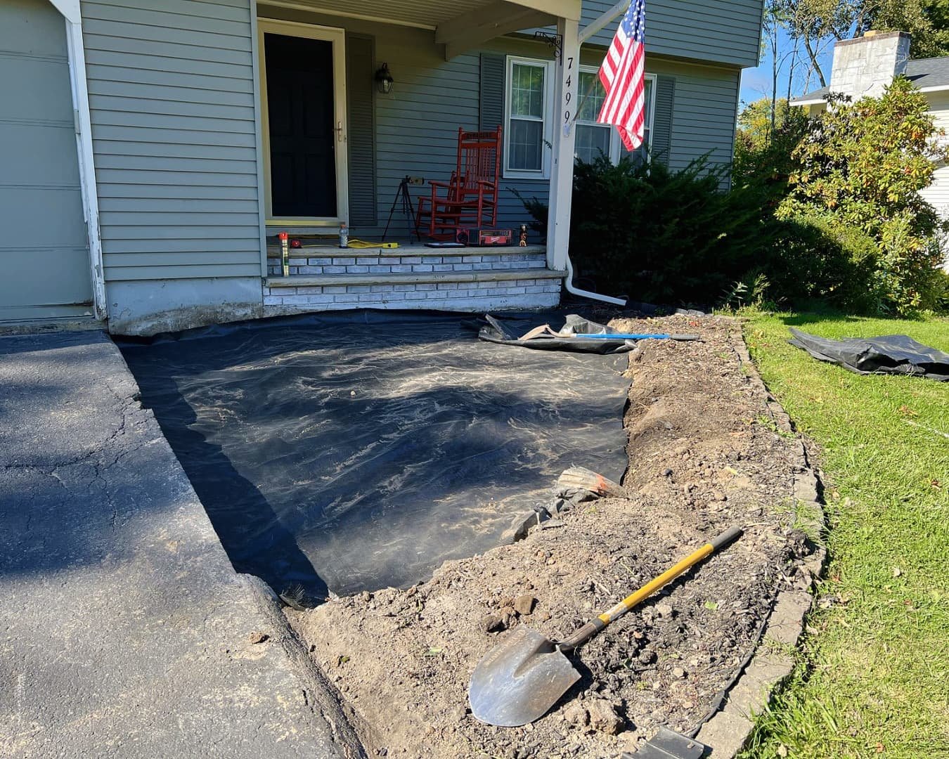 Curved front patio at an Upstate New York home with a smooth paver layout and finished outdoor entry space.