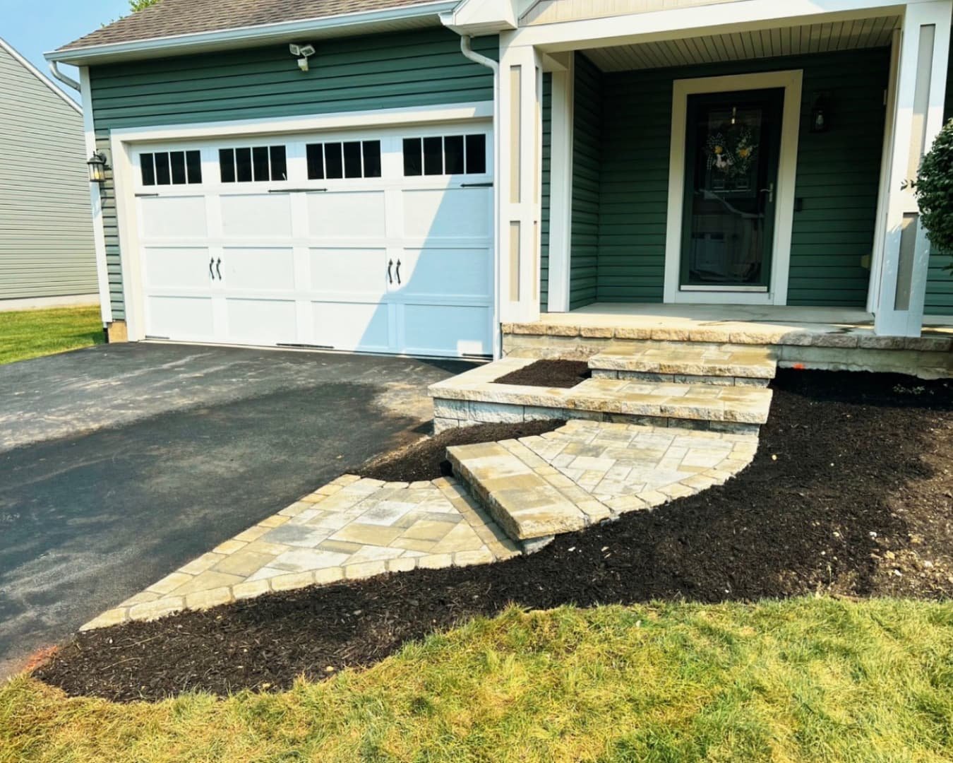 Hardscape materials and step build in progress at a Central New York home with active front entry construction.