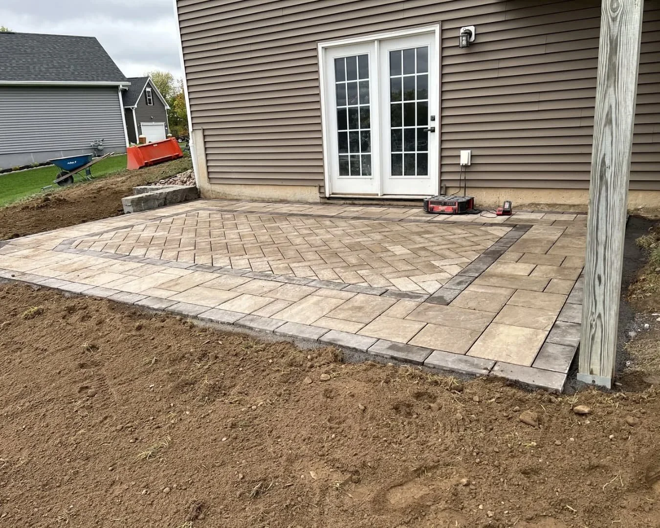 Backyard lawn view beside a new patio installation at an Upstate New York residential hardscape project.