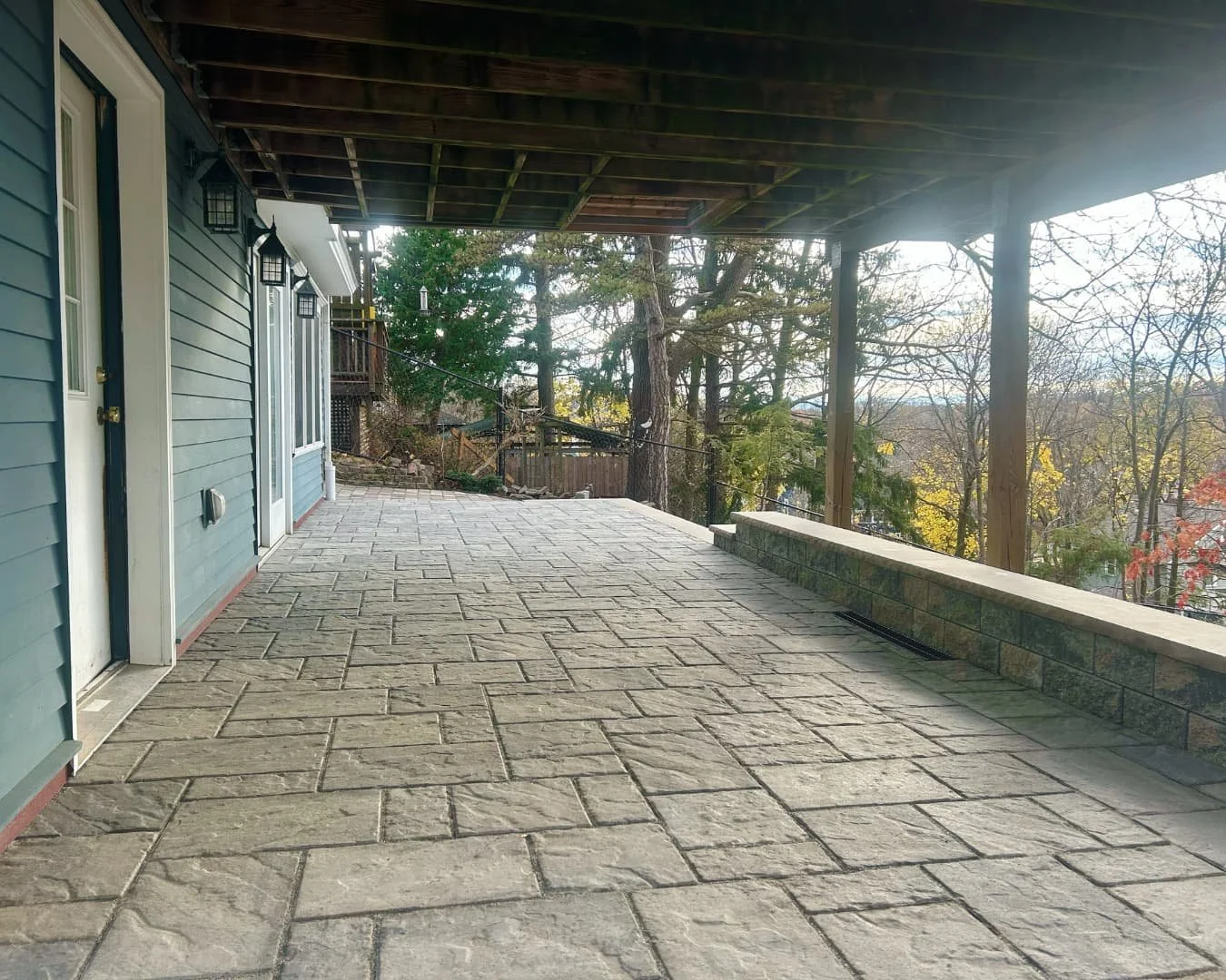 Covered paver patio and walkway installation by Pines and Pavers at a Central New York home.