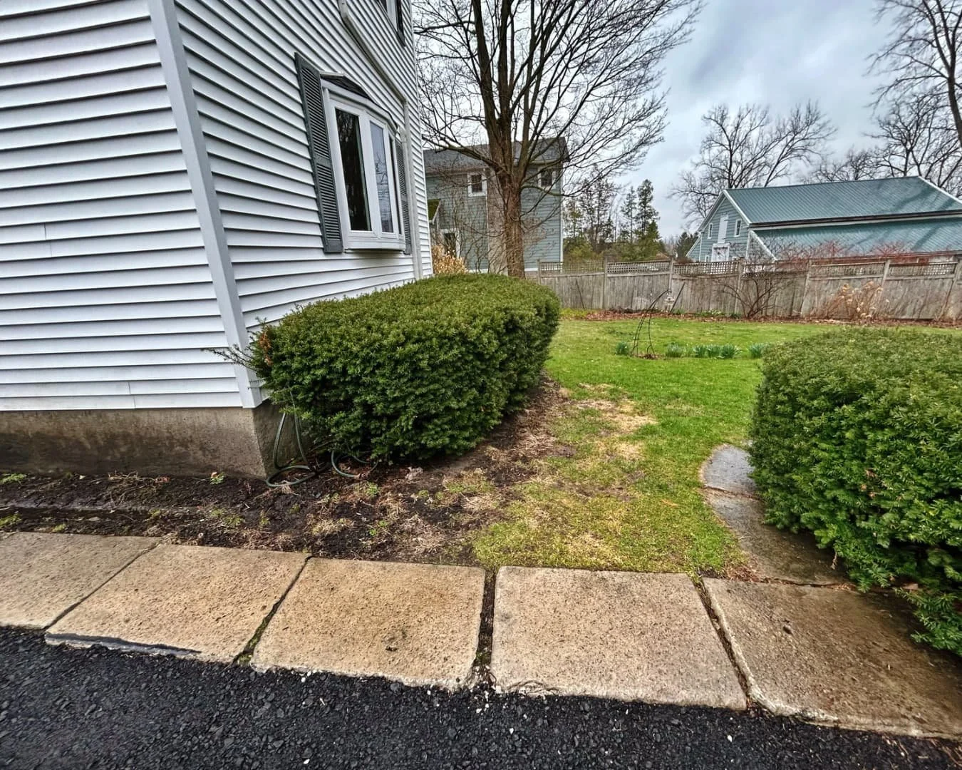 Side yard before paver installation by Pines and Pavers in Cazenovia, New York.