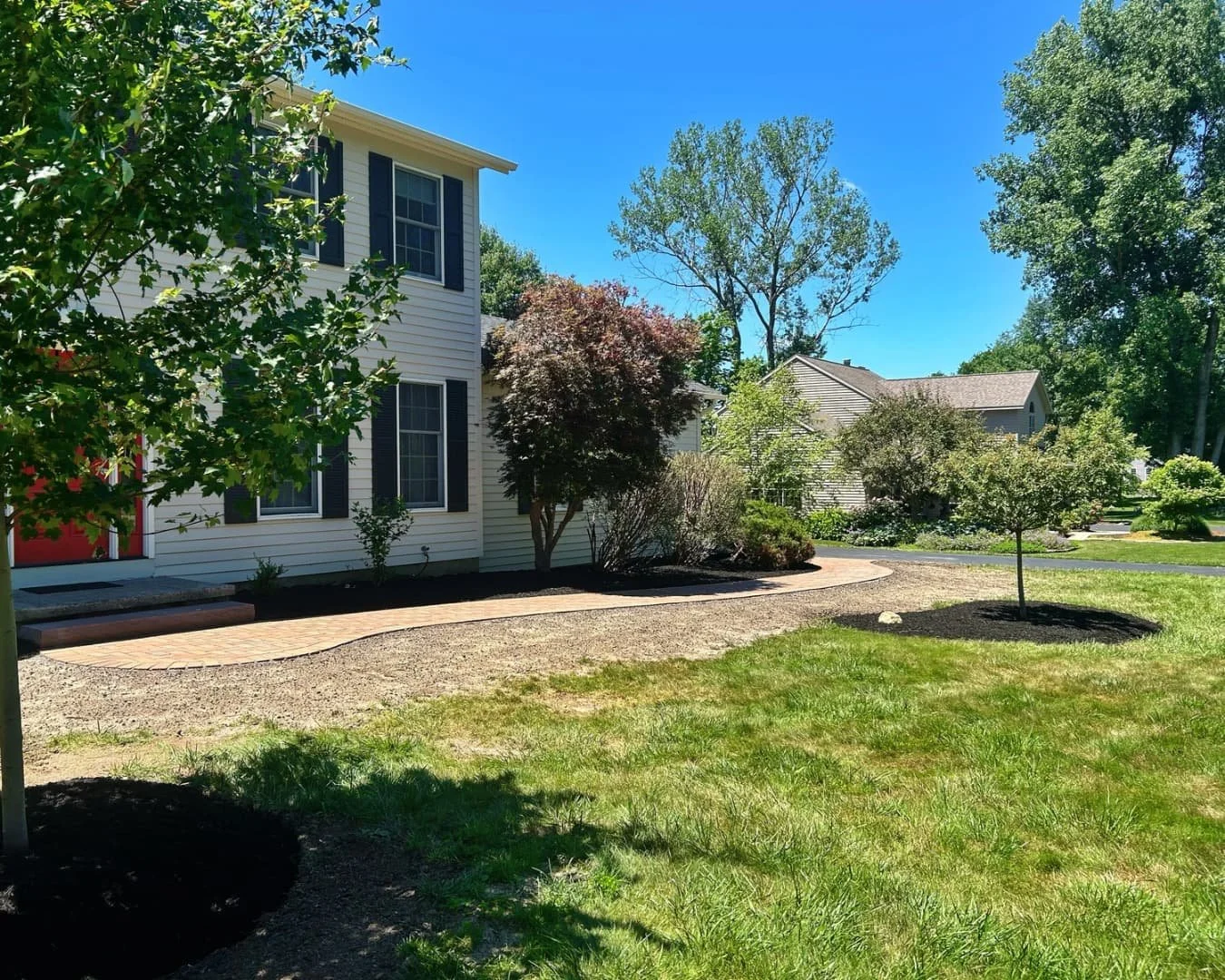 Front home landscape overview completed by Pines and Pavers in Manlius, New York.