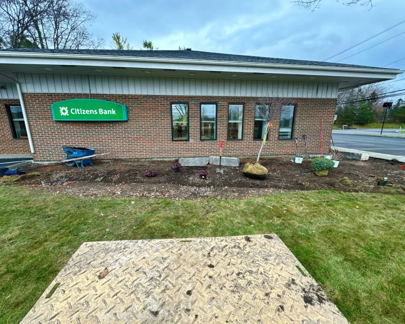 Landscape installation overview at Citizens Bank completed by Pines and Pavers in Cicero, New York.
