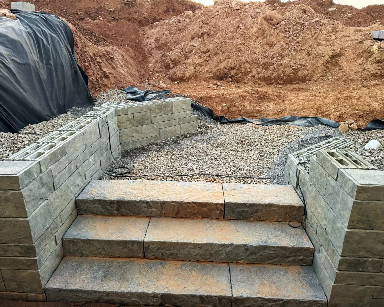 Step wall and patio construction detail by Pines and Pavers in Cazenovia, New York.