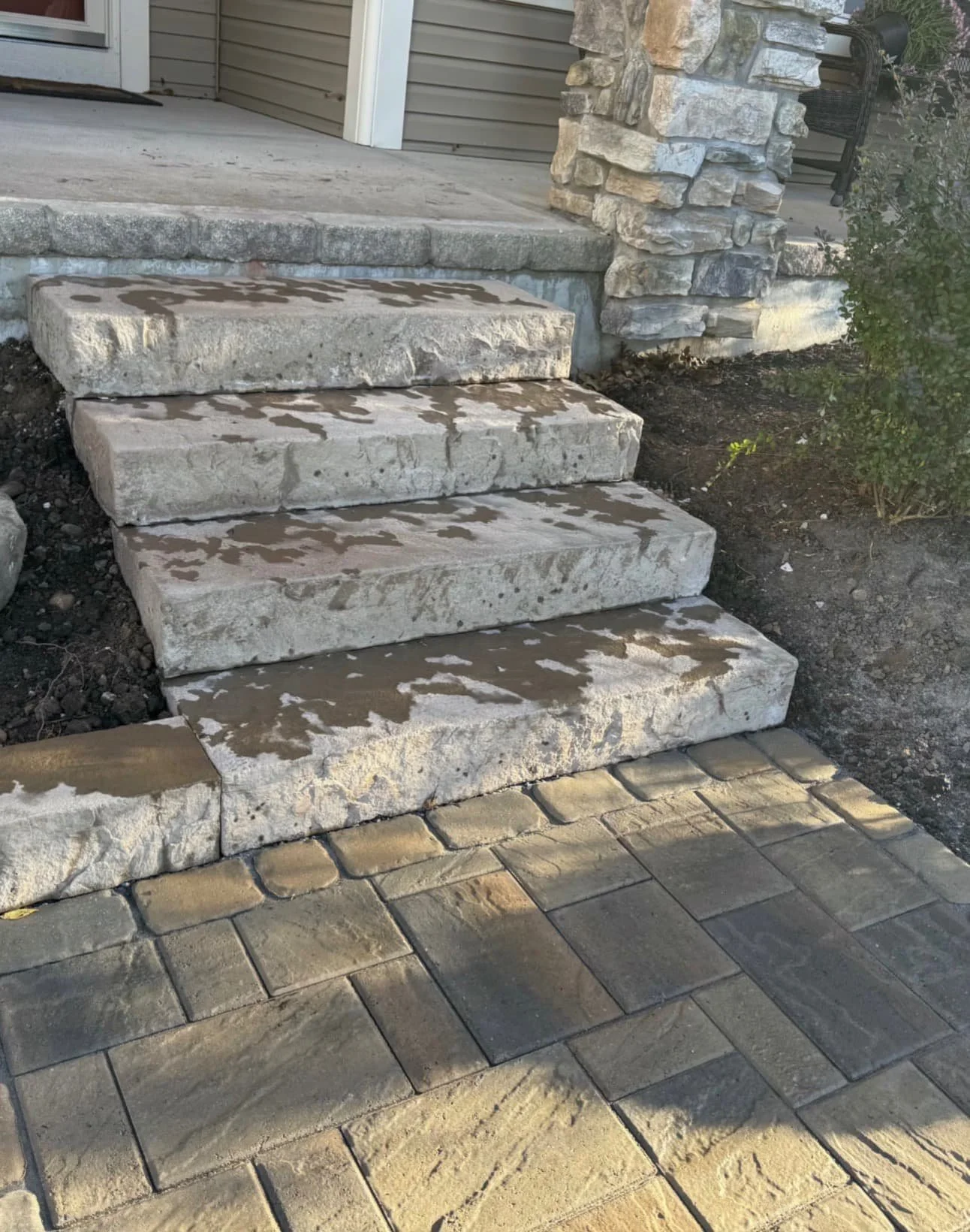 Paver step pattern detail at an Upstate New York home showing clean stone layout and border definition.