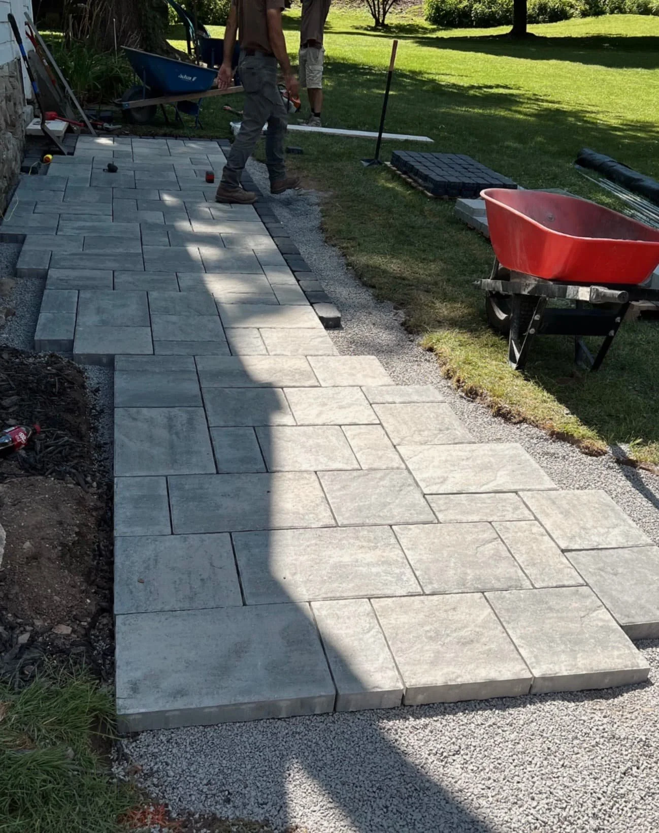 Front door paver landing at a Baldwinsville, NY home with a compact hardscape layout and neat border lines.