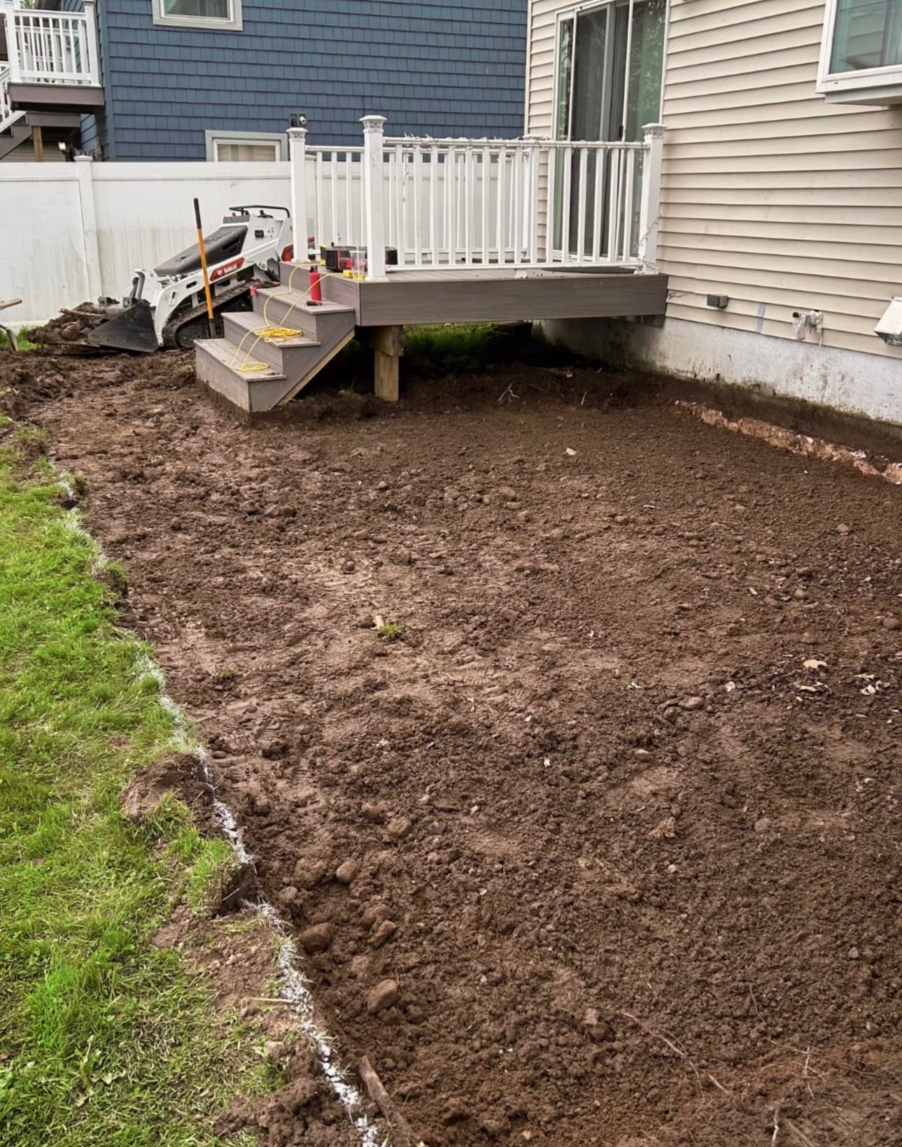 Graded backyard area prepared for hardscape installation at a Baldwinsville, NY residential project.