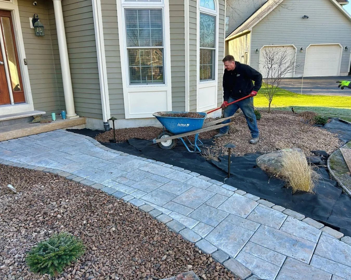 Front walkway through the landscape bed by Pines and Pavers in Fayetteville, New York.