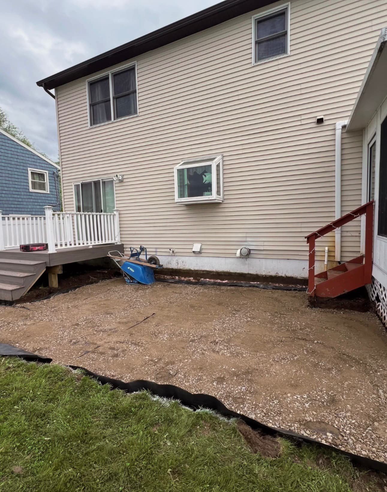 Backyard paver patio at a Central New York home with a curved edge and open lawn border.