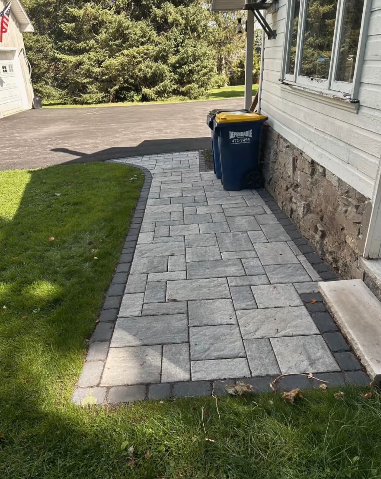 Front entry steps at an Upstate New York home with a clean stone finish and updated curb appeal.