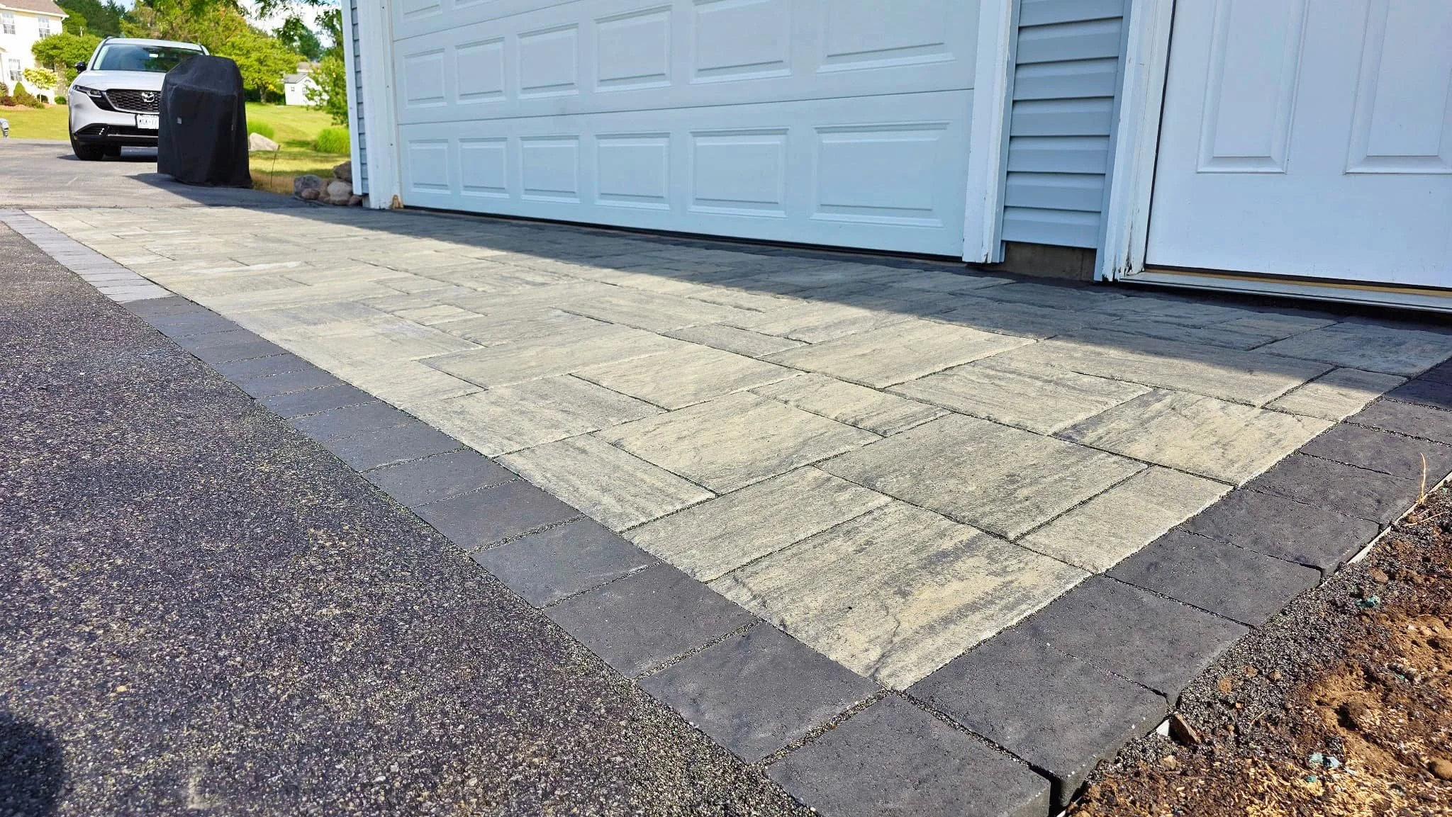 Restored concrete driveway area with a clean finished surface outside a Central New York home.