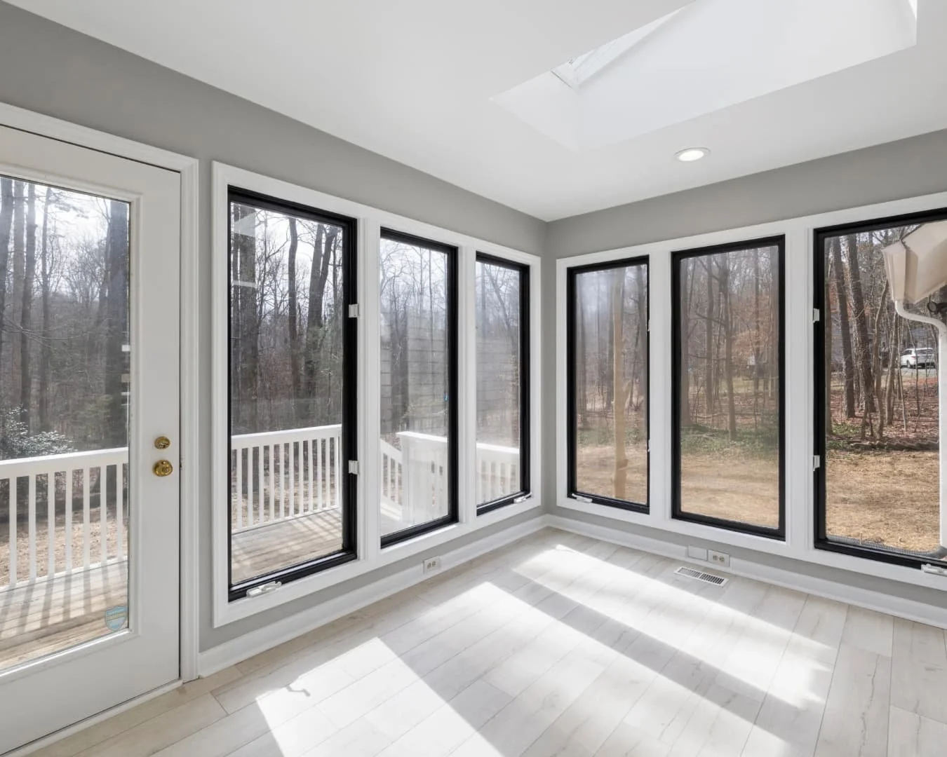 Bright sunroom inspiration with large windows, light seating, and garden views all around.