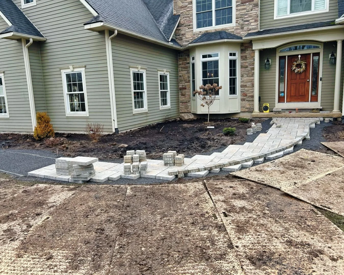 Curved front walkway overview by Pines and Pavers in Fayetteville, New York.
