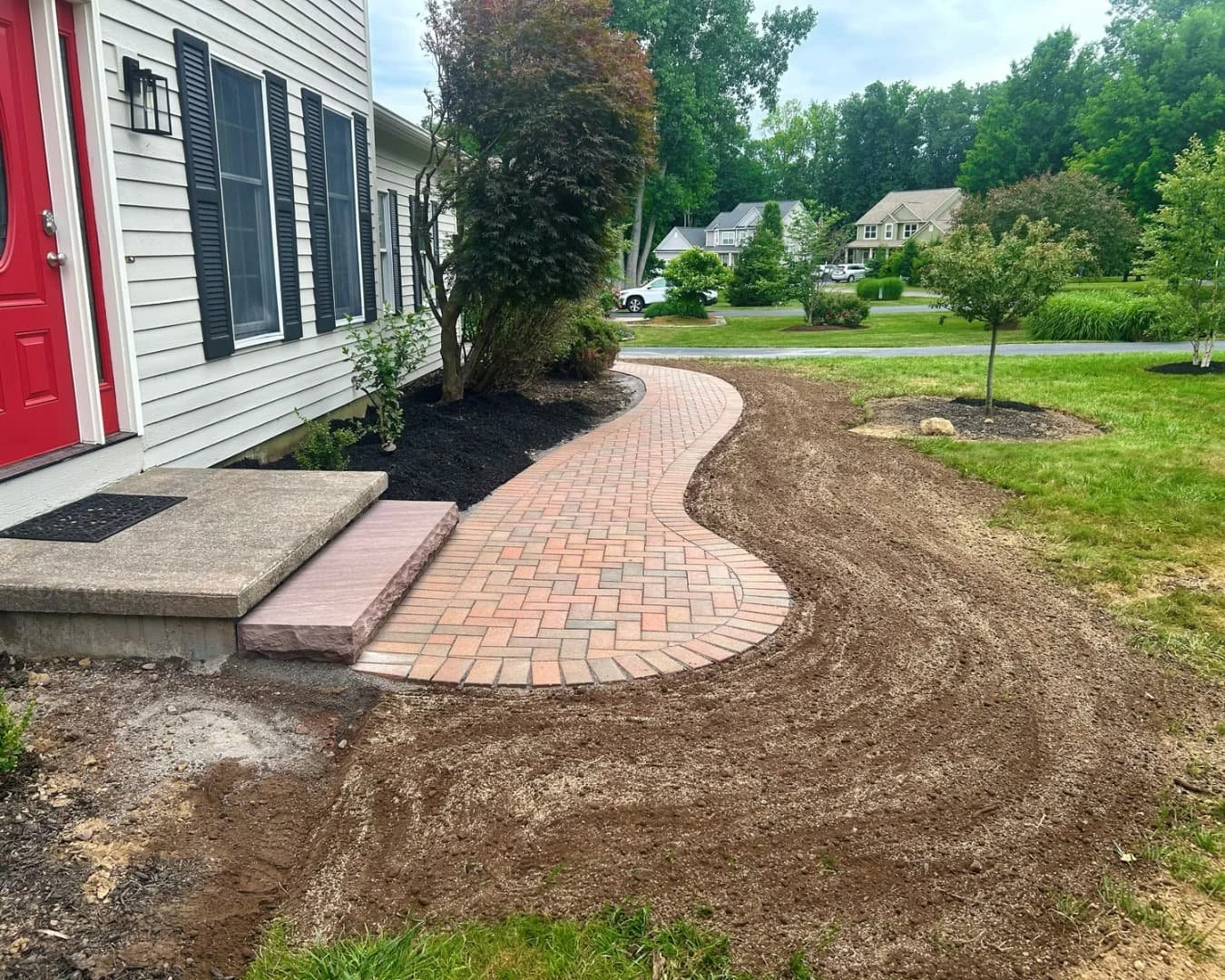Brick front walkway leading to the entry completed by Pines and Pavers in Manlius, New York.