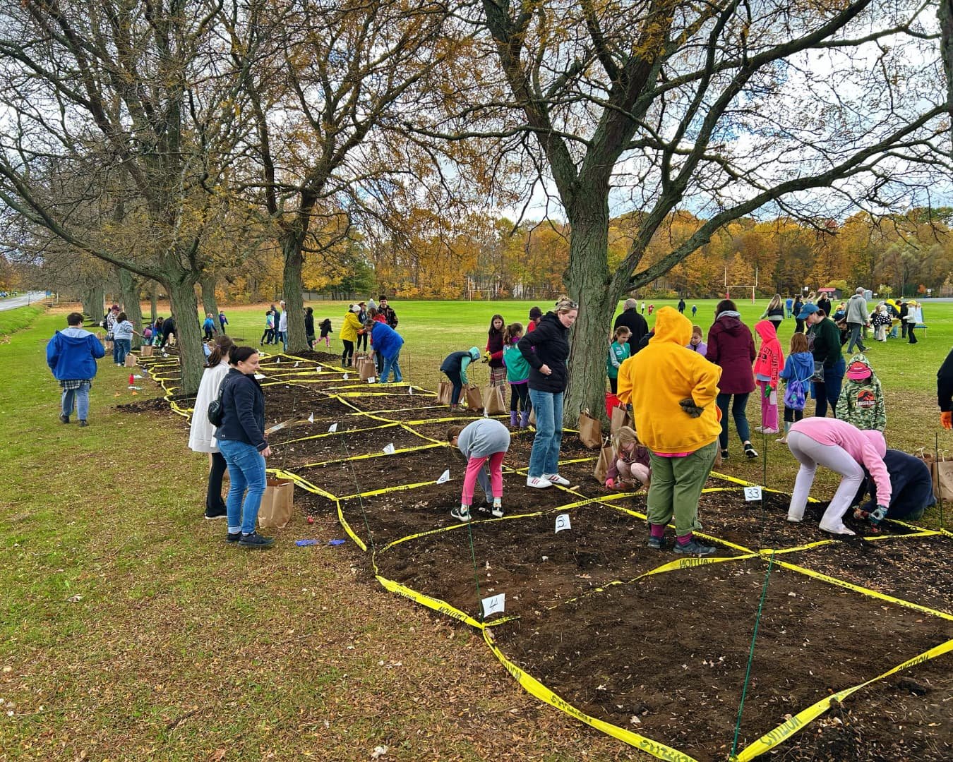 Community members and volunteers planting Reese’s Remembrance Garden at Lysander Park.
