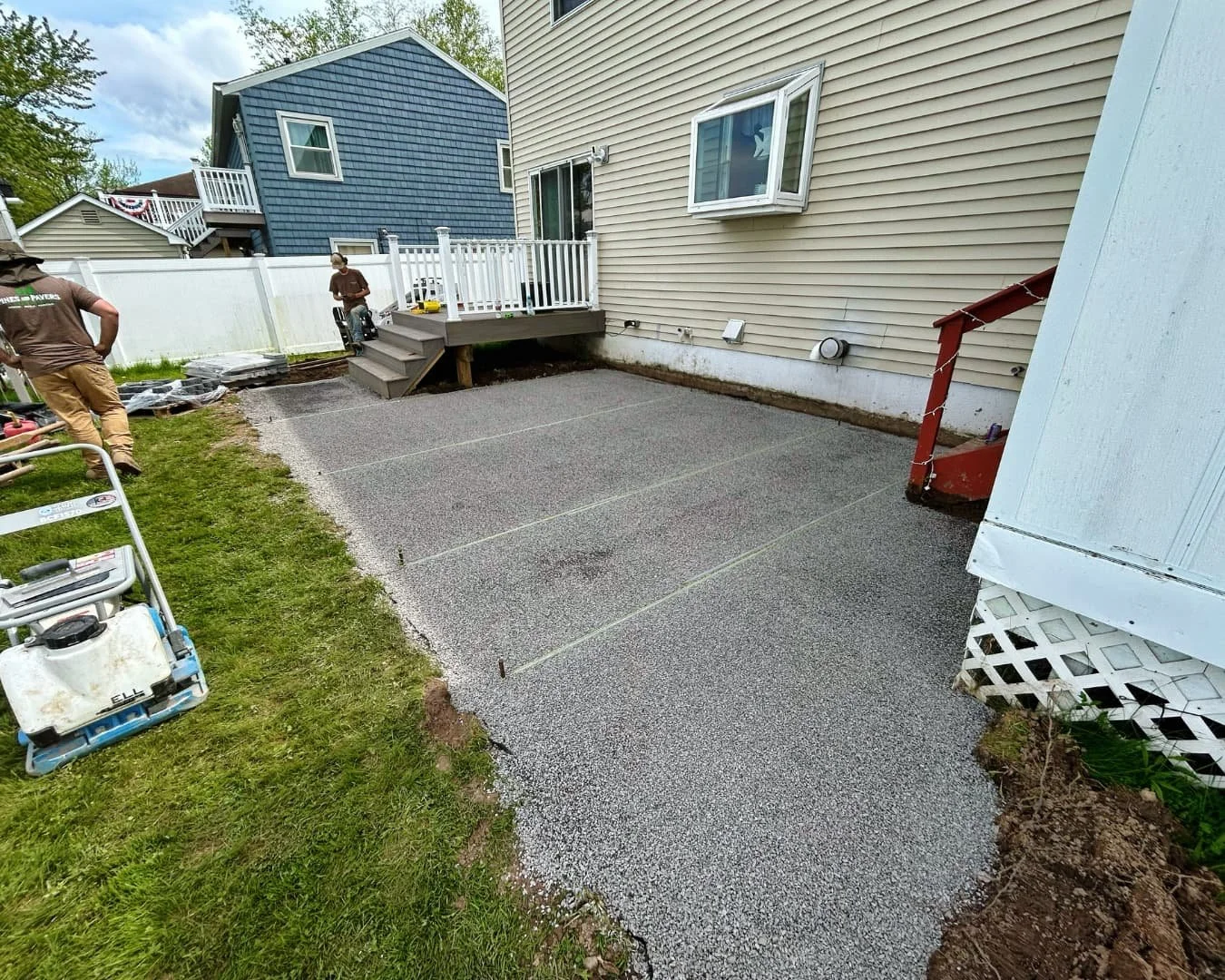 Rear concrete patio before the hardscape project by Pines and Pavers in Marcellus, New York.